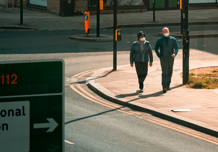 Couple walking in city with face masks